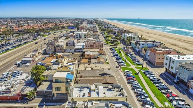 drone / aerial view with a beach view and a water view