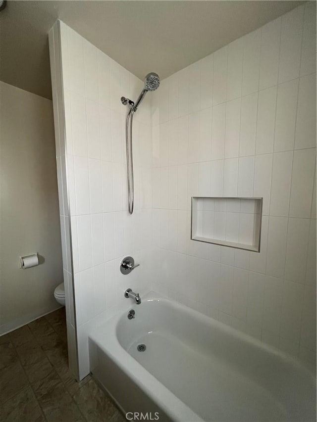 bathroom with tub / shower combination and toilet