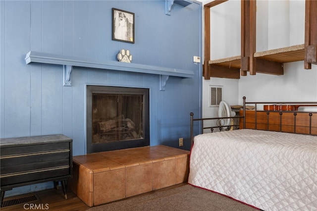 bedroom featuring visible vents and a fireplace with raised hearth