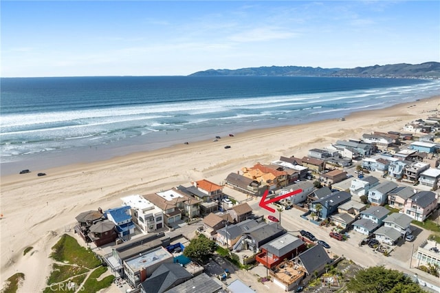 aerial view featuring a view of the beach and a water view