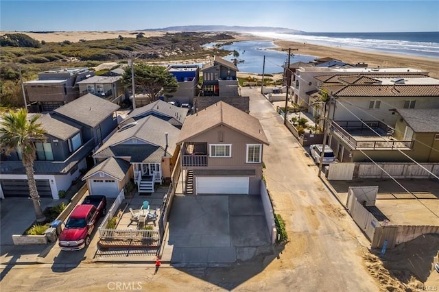 bird's eye view featuring a residential view, a beach view, and a water view