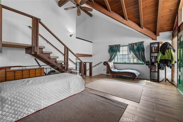 bedroom with high vaulted ceiling, beamed ceiling, wood ceiling, and wood finished floors