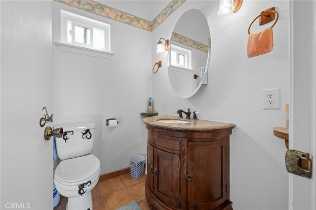 bathroom featuring tile patterned floors, toilet, vanity, and baseboards