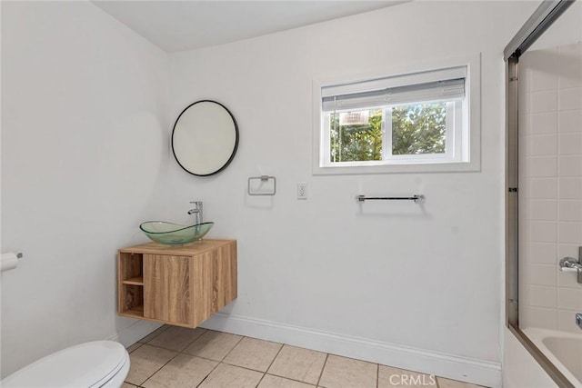 bathroom with vanity, baseboards, shower / bath combination, tile patterned floors, and toilet