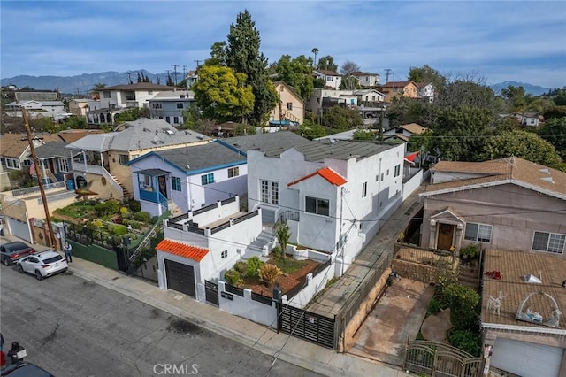 drone / aerial view featuring a residential view and a mountain view