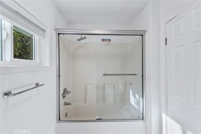 full bathroom with shower / bath combination with glass door