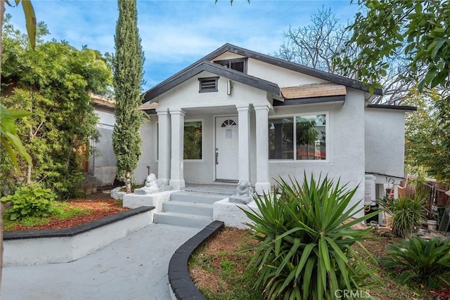 view of front of property with fence and stucco siding