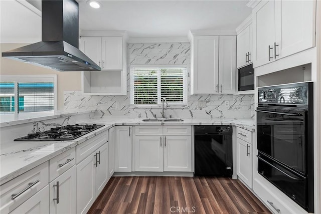 kitchen featuring island exhaust hood, a sink, black appliances, white cabinetry, and a warming drawer