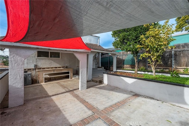 view of patio / terrace with fence and an outdoor kitchen