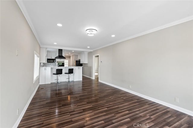 unfurnished living room with recessed lighting, dark wood-type flooring, crown molding, and baseboards