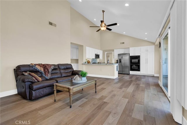 living room featuring visible vents, baseboards, ceiling fan, light wood-type flooring, and recessed lighting