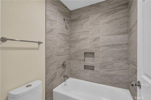 full bathroom featuring tub / shower combination and toilet