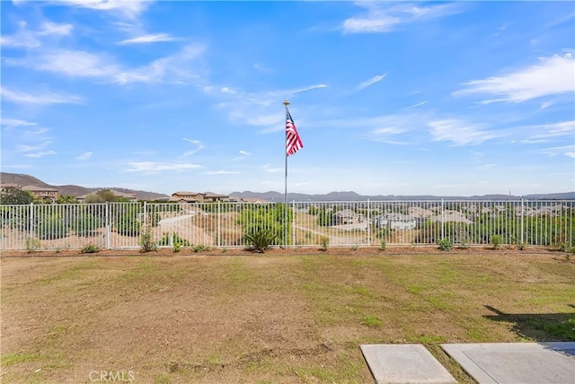 view of yard featuring fence and a mountain view