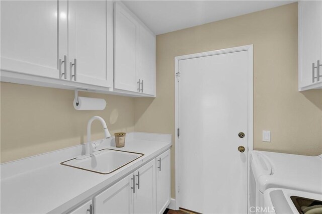 laundry room featuring a sink, cabinet space, and washing machine and clothes dryer