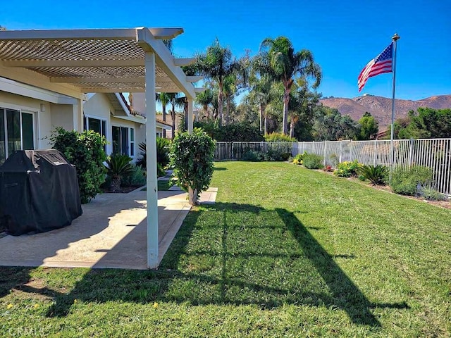 view of yard with a pergola, a fenced backyard, a mountain view, and a patio