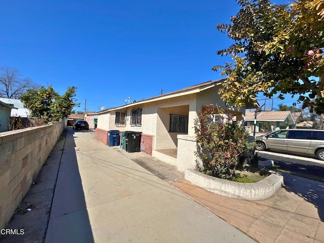 view of front of property with stucco siding and fence