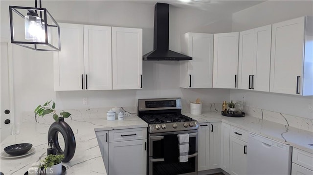 kitchen featuring light stone countertops, range with two ovens, white dishwasher, white cabinets, and wall chimney exhaust hood