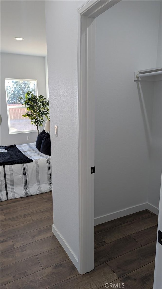 interior space with baseboards and dark wood-type flooring