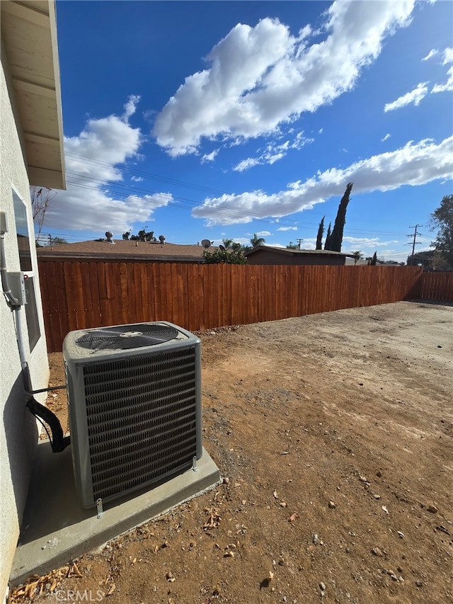 view of yard featuring cooling unit and fence