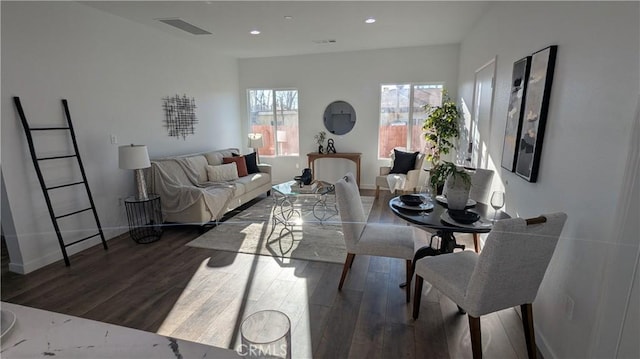 living room with visible vents, recessed lighting, wood finished floors, and baseboards