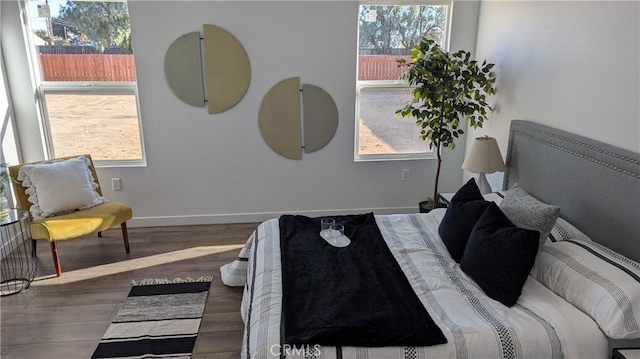 bedroom with baseboards and wood finished floors