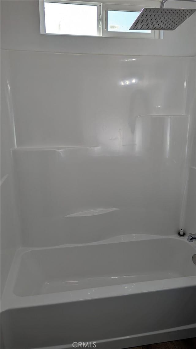 bathroom with shower / washtub combination