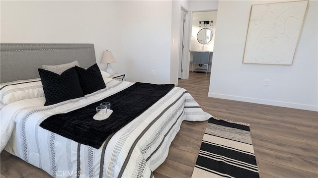 bedroom featuring baseboards and wood finished floors