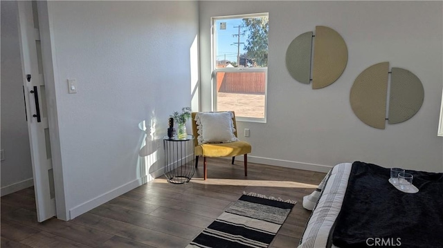 bedroom featuring baseboards and wood finished floors