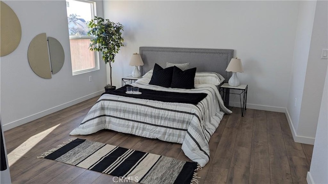 bedroom featuring wood finished floors and baseboards