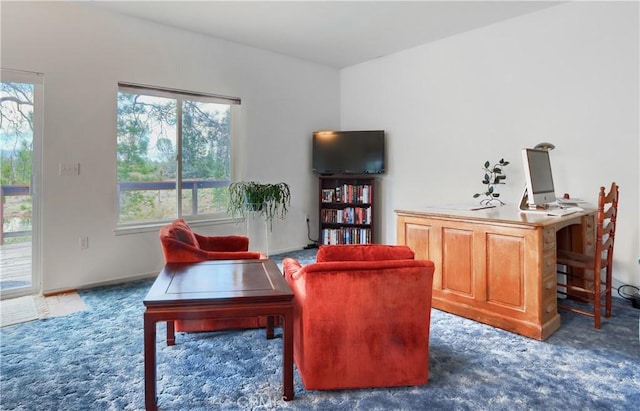 sitting room featuring carpet flooring and baseboards