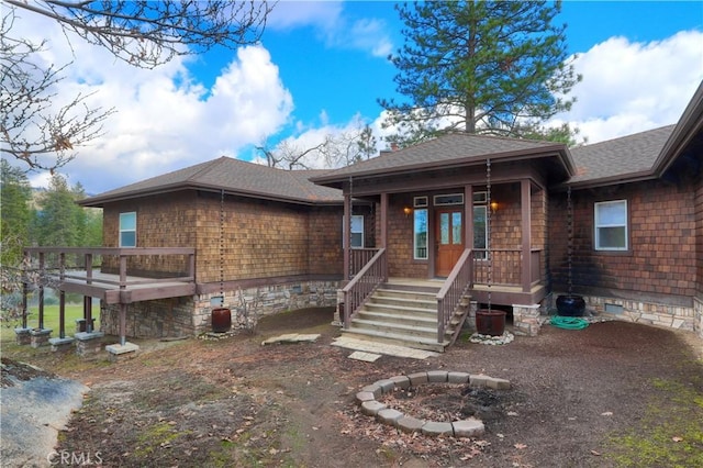 view of front of home featuring a porch, roof with shingles, and crawl space