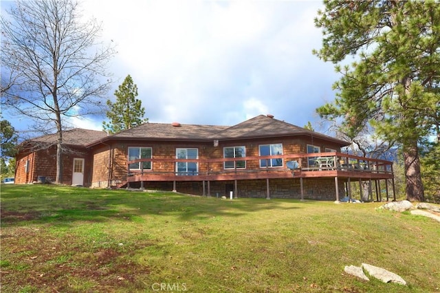 back of house with a yard and a wooden deck