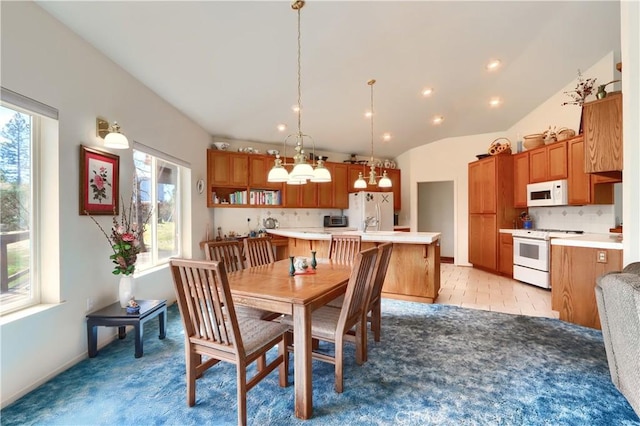 dining space with vaulted ceiling, recessed lighting, and a wealth of natural light