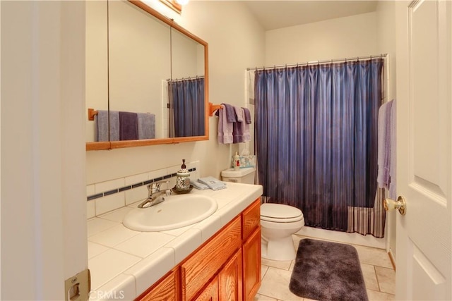 full bath featuring tile patterned floors, curtained shower, toilet, and vanity