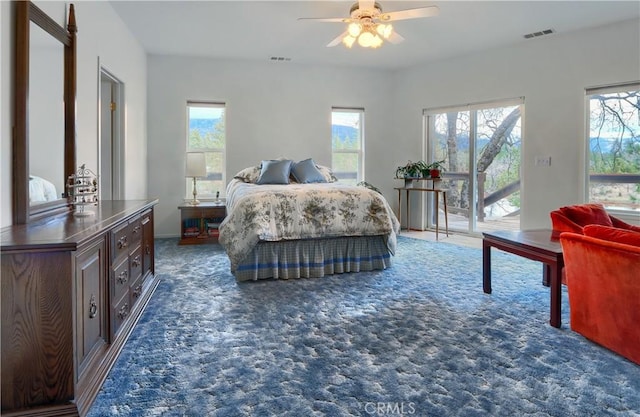 bedroom featuring access to exterior, multiple windows, carpet, and visible vents