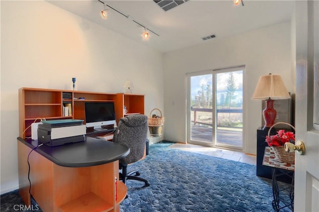 carpeted home office featuring tile patterned flooring, rail lighting, and visible vents