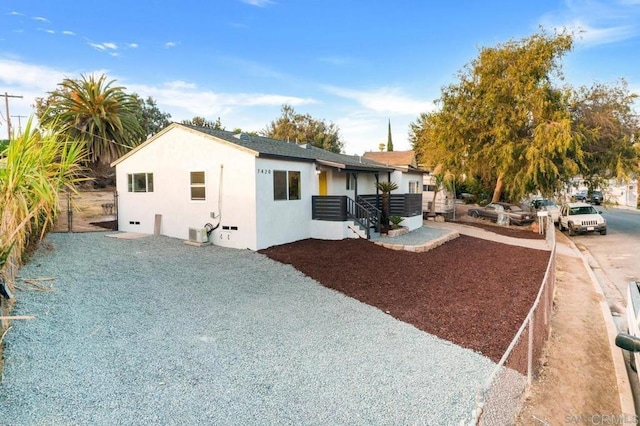 view of front of property with stucco siding and fence