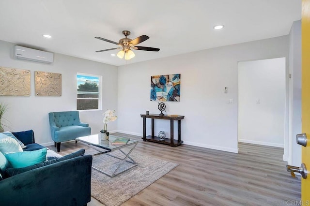 sitting room featuring recessed lighting, wood finished floors, baseboards, and a wall mounted AC