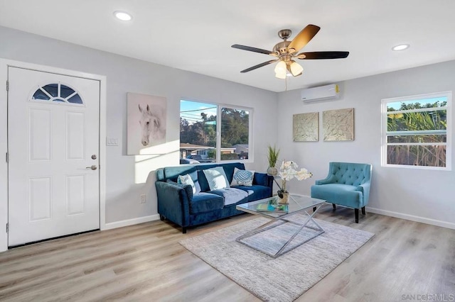 living area featuring recessed lighting, baseboards, light wood finished floors, and a wall mounted AC