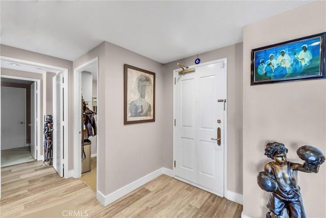 entryway featuring light wood-style floors and baseboards