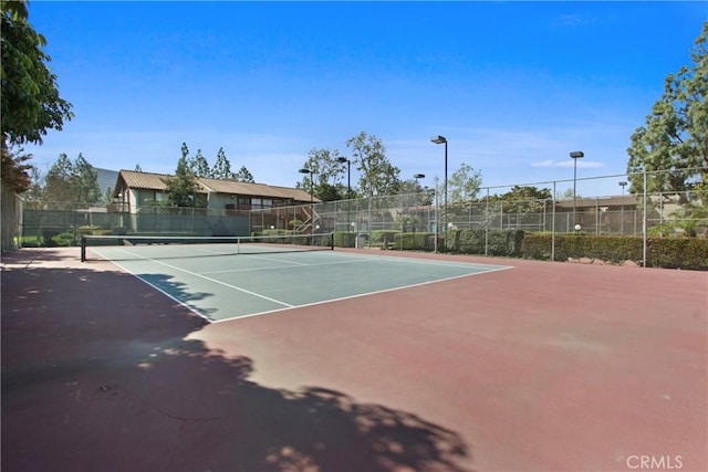 view of tennis court with fence