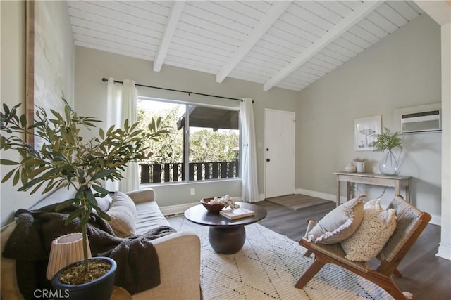 living area featuring baseboards, vaulted ceiling with beams, a wall unit AC, and wood finished floors