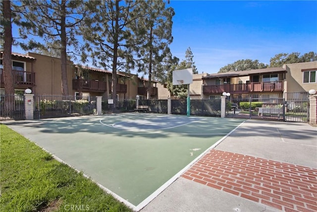 view of basketball court featuring a residential view and community basketball court