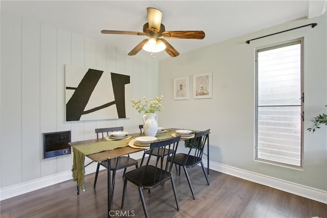 dining area featuring heating unit, wood finished floors, baseboards, and ceiling fan