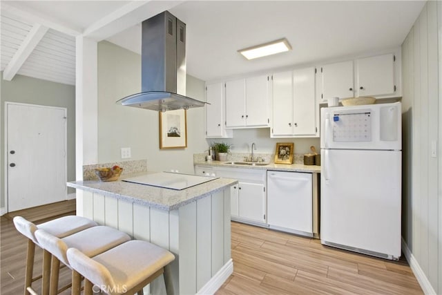 kitchen featuring island exhaust hood, a sink, white appliances, light wood-style floors, and white cabinets