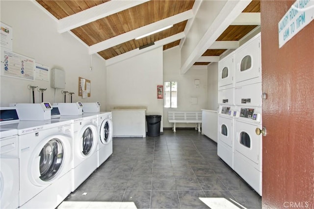 community laundry room featuring washing machine and clothes dryer, stacked washing maching and dryer, wood ceiling, and dark tile patterned floors