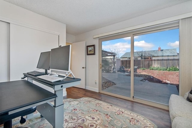 home office with wood finished floors, baseboards, and a textured ceiling