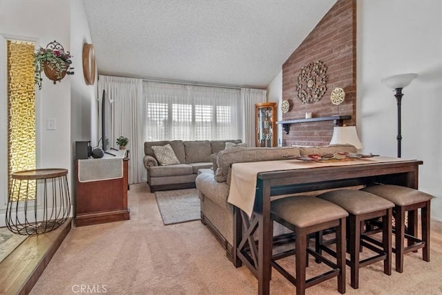 living room featuring light colored carpet, a textured ceiling, and lofted ceiling