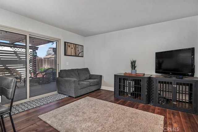 living room featuring baseboards and wood finished floors