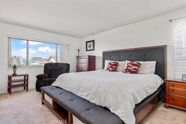 bedroom featuring carpet flooring and a textured ceiling